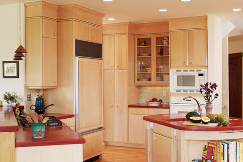 Concrete countertops in a rich terra-cotta color and handmade Mexican tile warm up the kitchen.